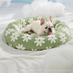 CozyPaw Donut Dog Bed – Modern Design, Soft & Warm, Washable Dog lying on a green floral-patterned pet bed in a cozy setting