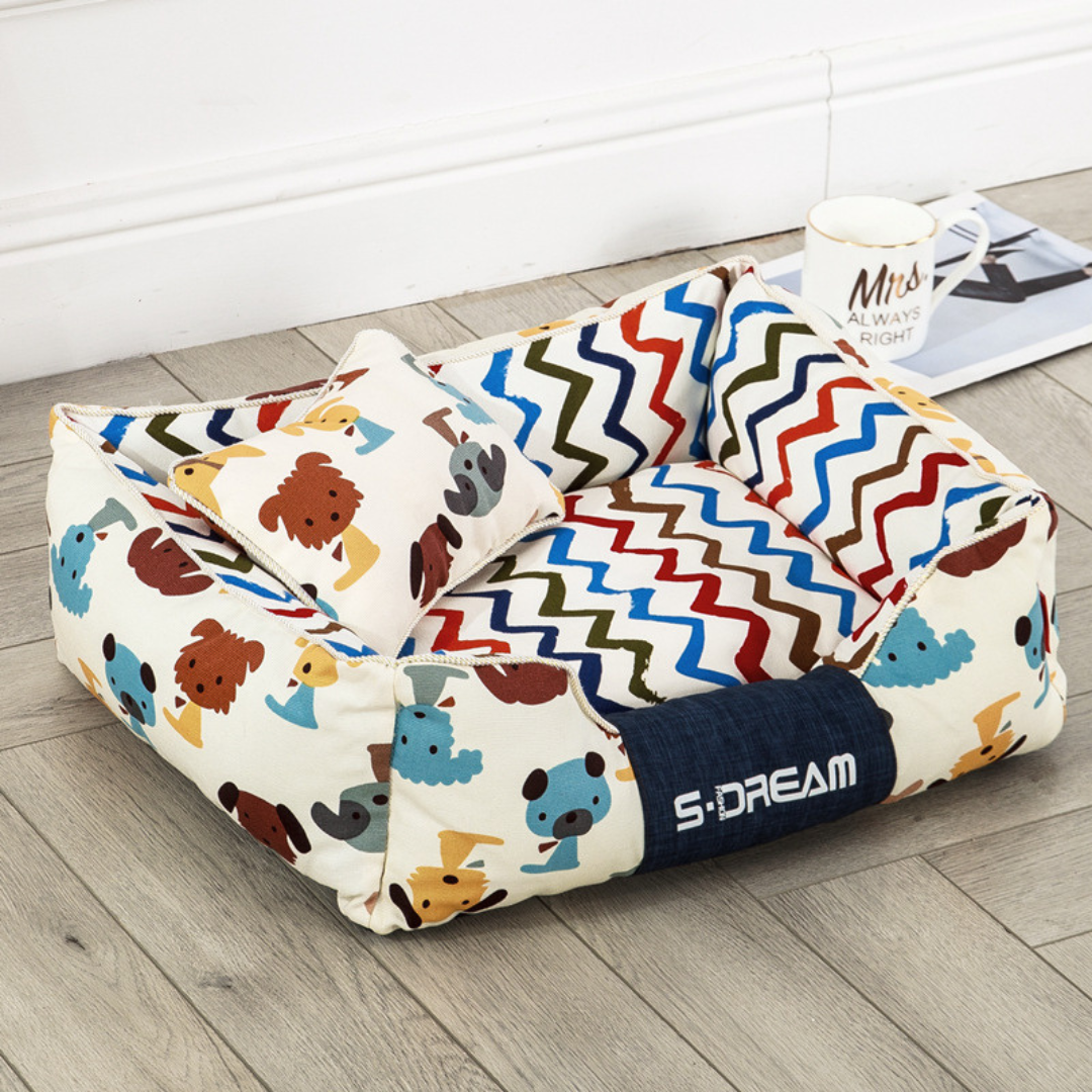 Sofa Dog Bed – Washable, Anti-Chew, Ultra Soft & Detachable with animal pattern and zigzag design on a wooden floor.