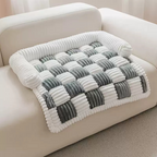 Fluffy Fuzzy Calming Dog Bed Sofa Protector Pet Mat Gray and white checkered blanket on a beige sofa