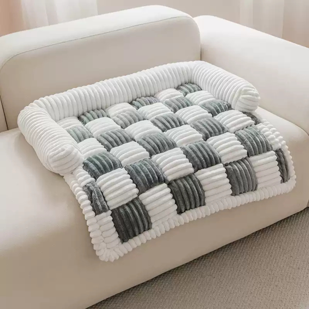 Fluffy Fuzzy Calming Dog Bed Sofa Protector Pet Mat Gray and white checkered blanket on a beige sofa