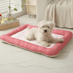 Cooling Dog Bed Small white dog lying on a pink and white cooling pet bed in a cozy room.
