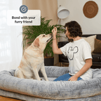 Human Dog Bed Person sitting on a large dog bed with a dog, with text 'Bond with your furry friend' above.